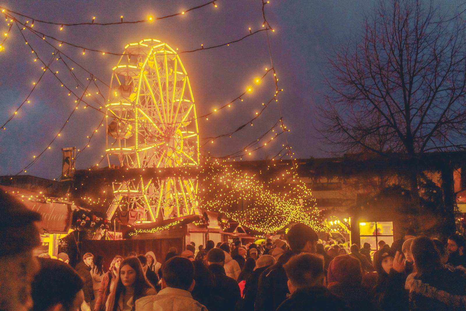 Warm and joyful atmosphere at Kassel Christmas market with lights and a Ferris wheel.